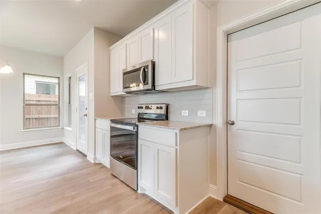 a kitchen with granite countertop white cabinets and a granite counter tops