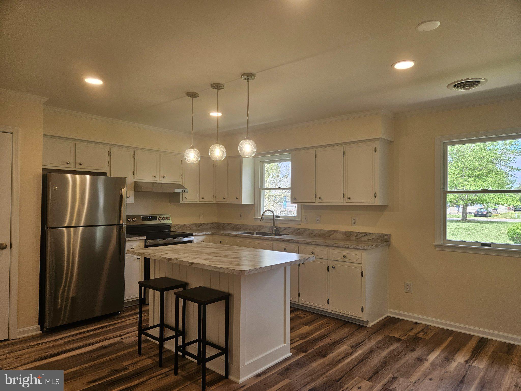 5 7th Street Ridgely, MD 21660 - Photo 3 of 12 a kitchen with a stove a sink and a refrigerator