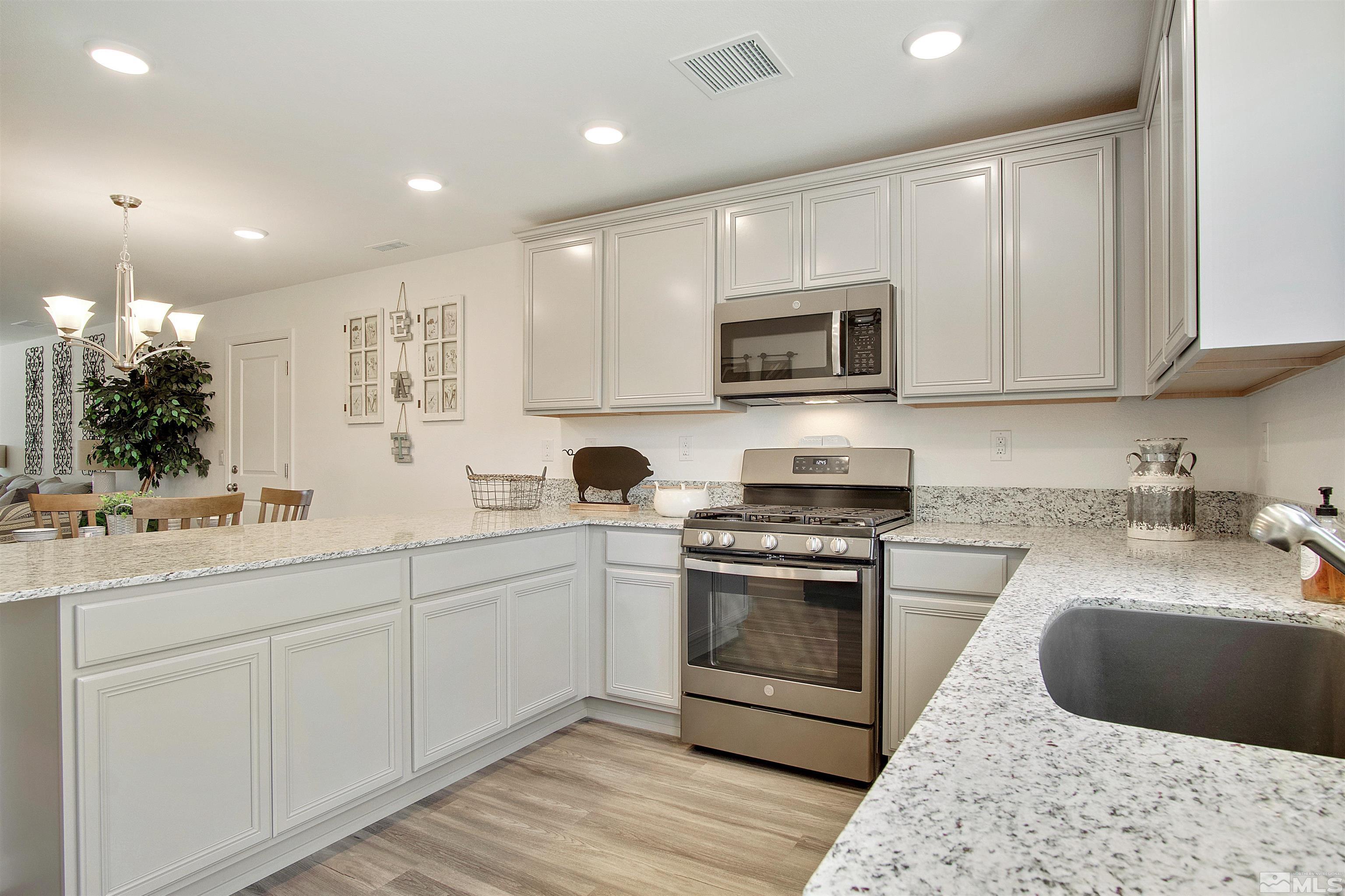 9320 Carter Reno, NV 89506 - Photo 1 of 7 a kitchen with stainless steel appliances granite countertop a stove a sink and a microwave