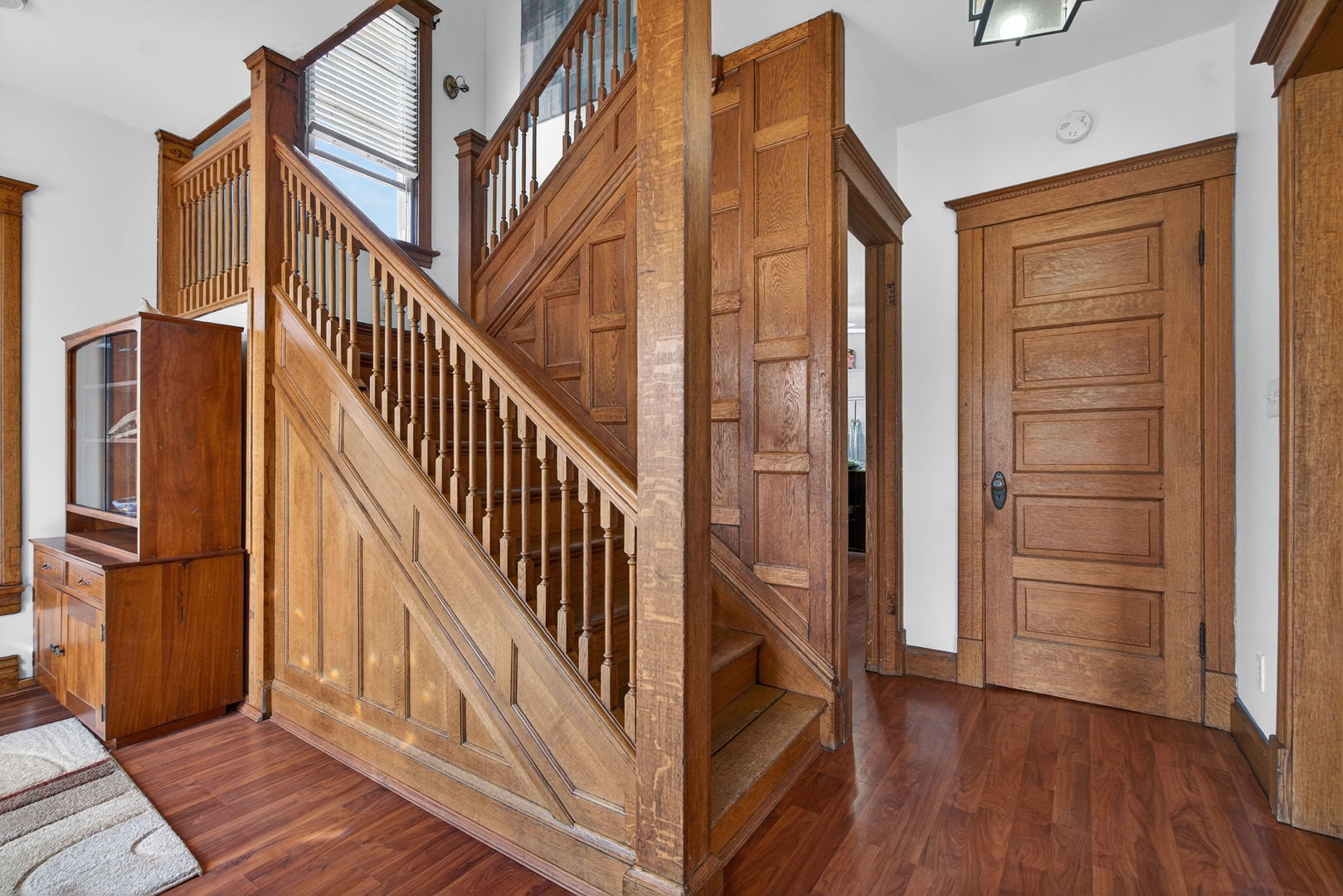 206 West Delaware Street Dwight, IL 60420 - Photo 5 of 42 a view of a hallway with wooden floor and staircase