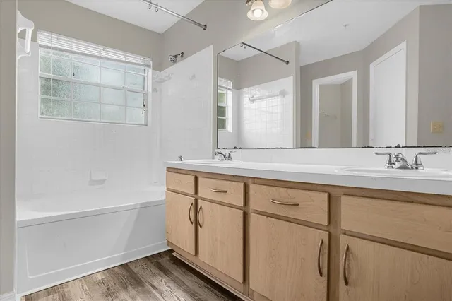 a spacious bathroom with a shower sink and mirror