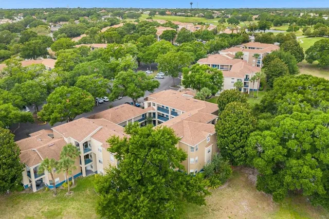 an aerial view of residential houses with outdoor space and river
