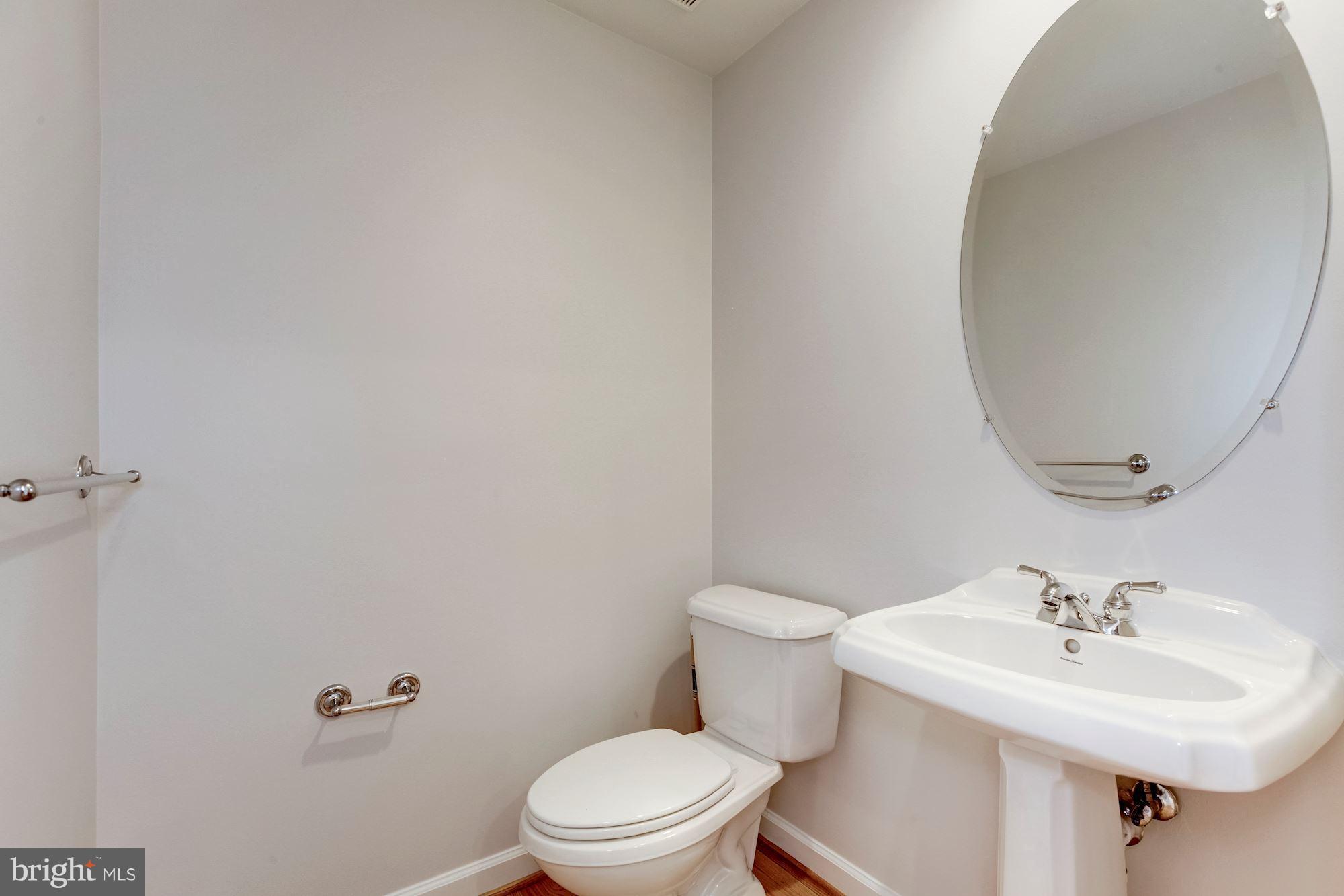 2316 Plyers Mill Road Silver Spring, MD 20902 - Photo 14 of 24 a bathroom with a sink a mirror and toilet