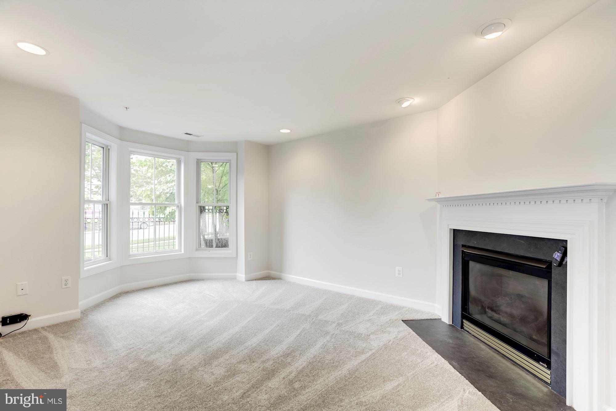 2316 Plyers Mill Road Silver Spring, MD 20902 - Photo 3 of 24 a view of empty room with a fireplace