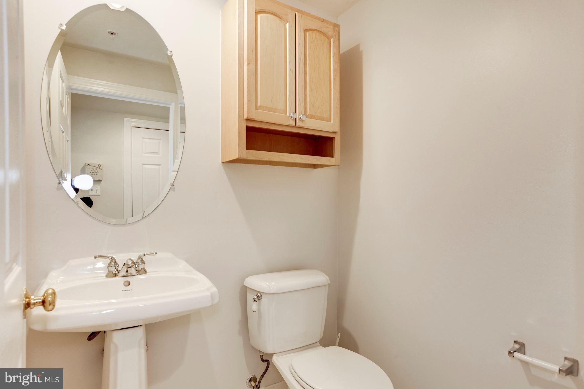 2316 Plyers Mill Road Silver Spring, MD 20902 - Photo 4 of 24 a bathroom with a sink mirror and toilet