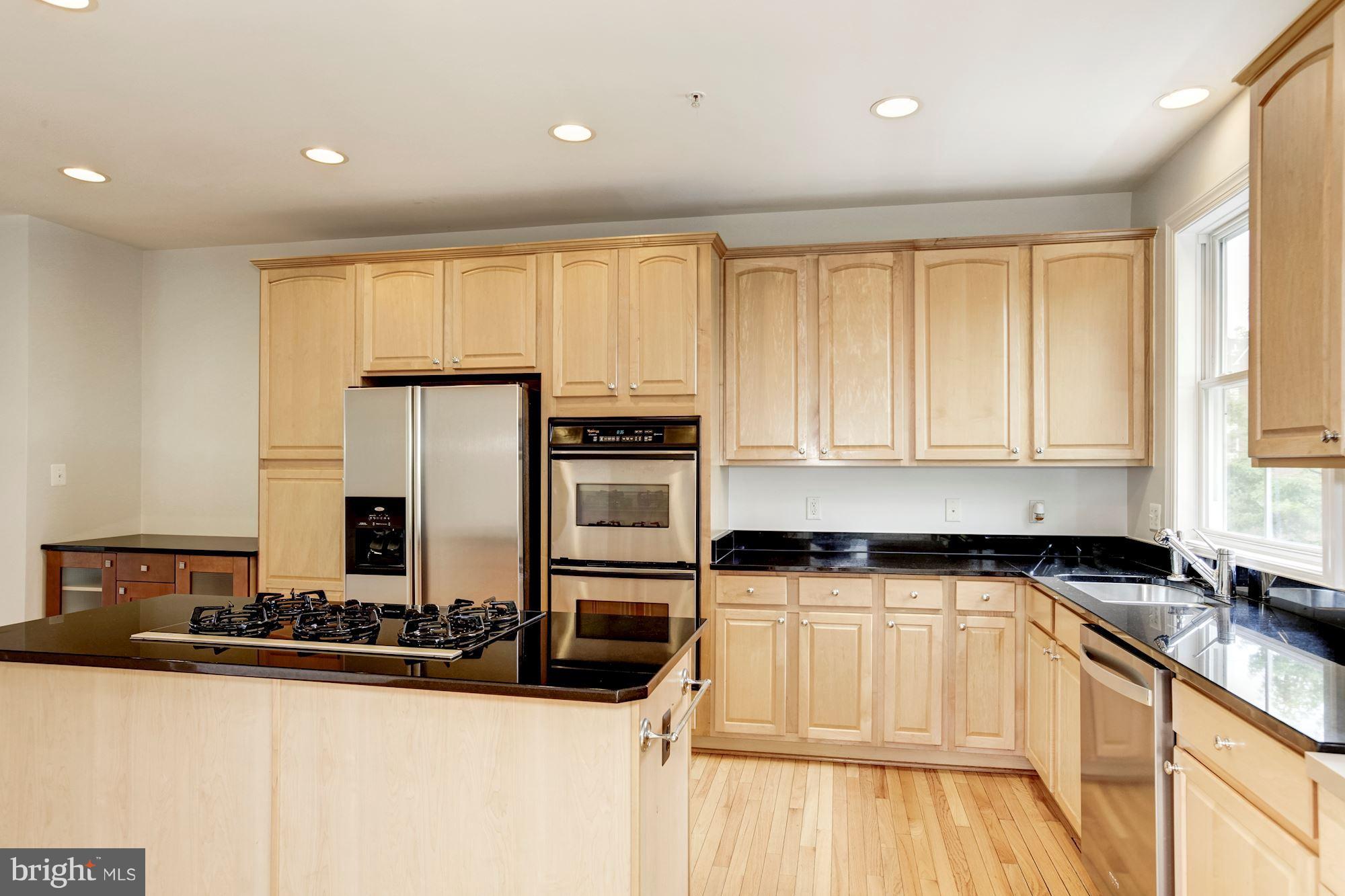 2316 Plyers Mill Road Silver Spring, MD 20902 - Photo 10 of 24 a kitchen with stainless steel appliances granite countertop a stove a sink and a microwave