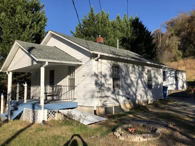 a backyard of a house with outdoor seating