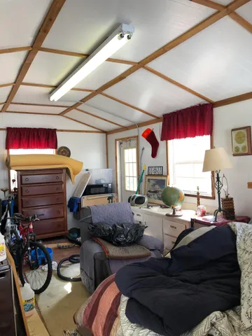 a living room with furniture fireplace and a window