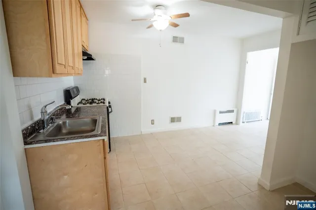 a kitchen with a sink a stove and cabinets