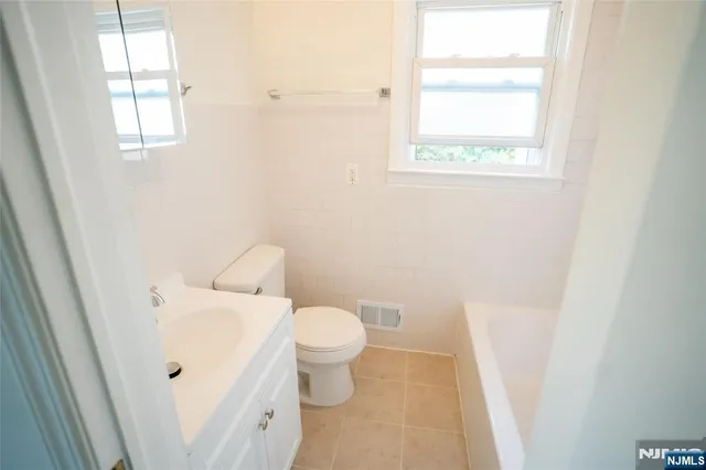 a white toilet sitting next to a bathroom sink
