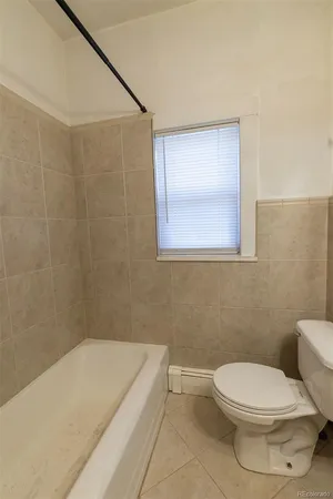 a bathroom with a sink shower and a mirror