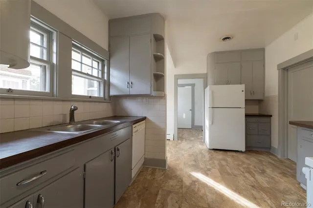 a kitchen with a refrigerator and a sink