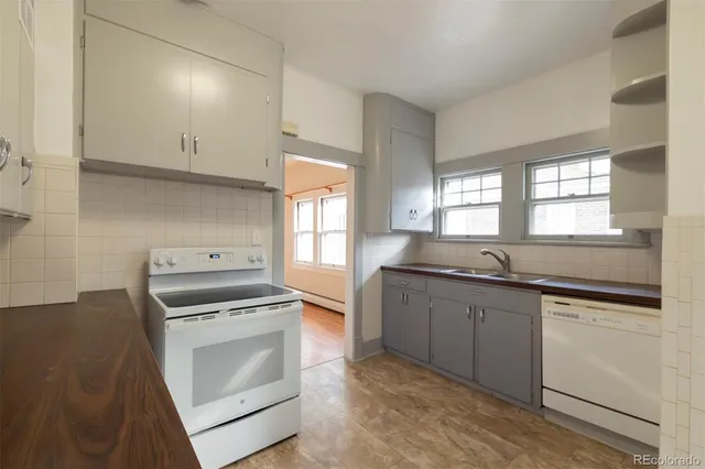 a kitchen with granite countertop cabinets stainless steel appliances and a window