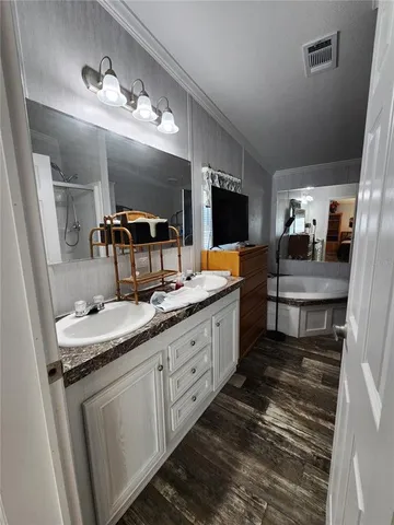 a large bathroom with double vanity and a mirror or bathtub