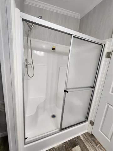 a bathroom with a glass shower door