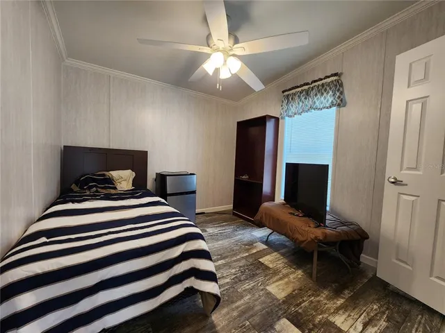 a bedroom with bed and a chandelier