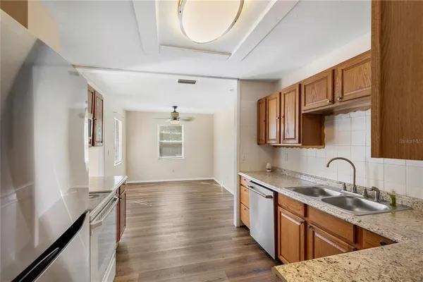 a kitchen with sink cabinets and wooden floor