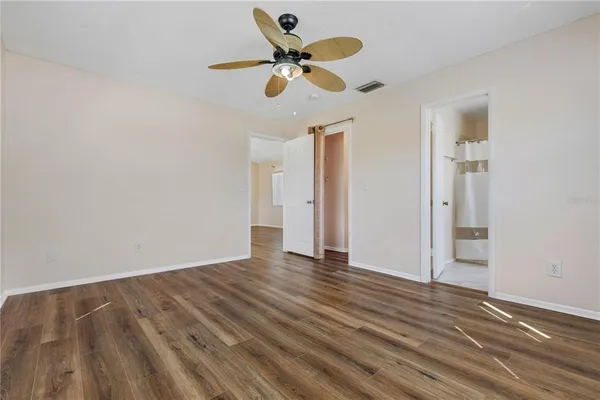 a view of an empty room with wooden floor