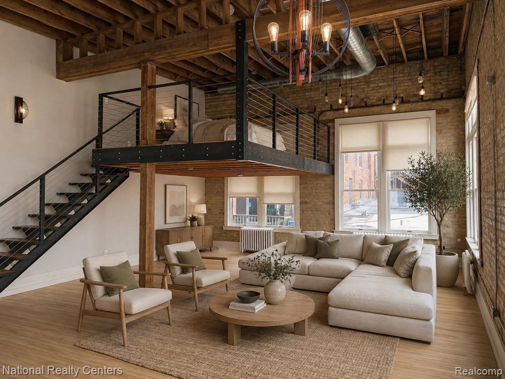 17 West Lawrence Street, Unit 2D Pontiac, MI 48342 - Photo 1 of 12 Open-concept living space with exposed brick walls, wood-finish flooring, and a visible wood beam ceiling