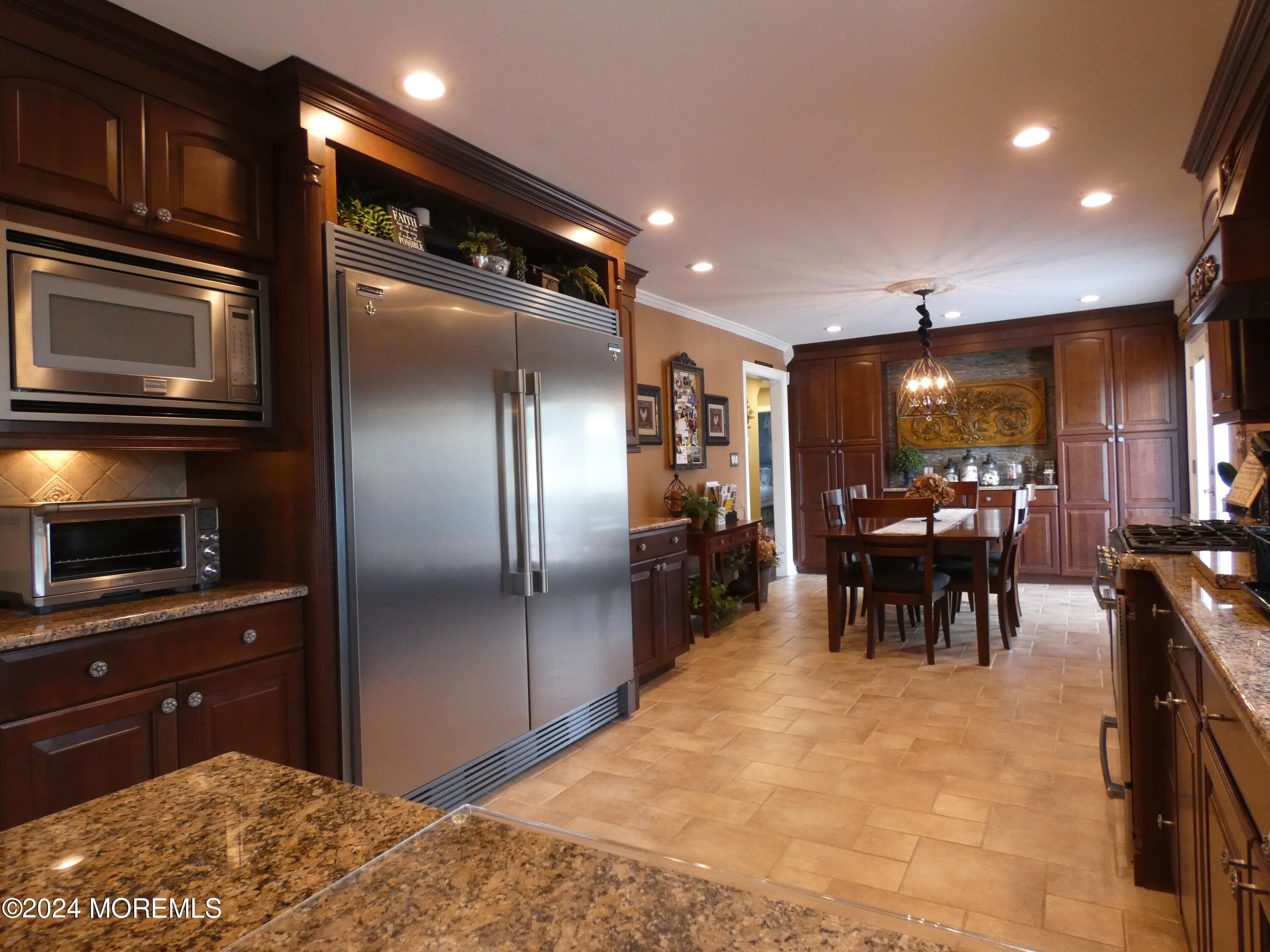 3 Springhill Drive Howell, NJ 07731 - Photo 15 of 37 a kitchen with stainless steel appliances kitchen island granite countertop a refrigerator and a sink
