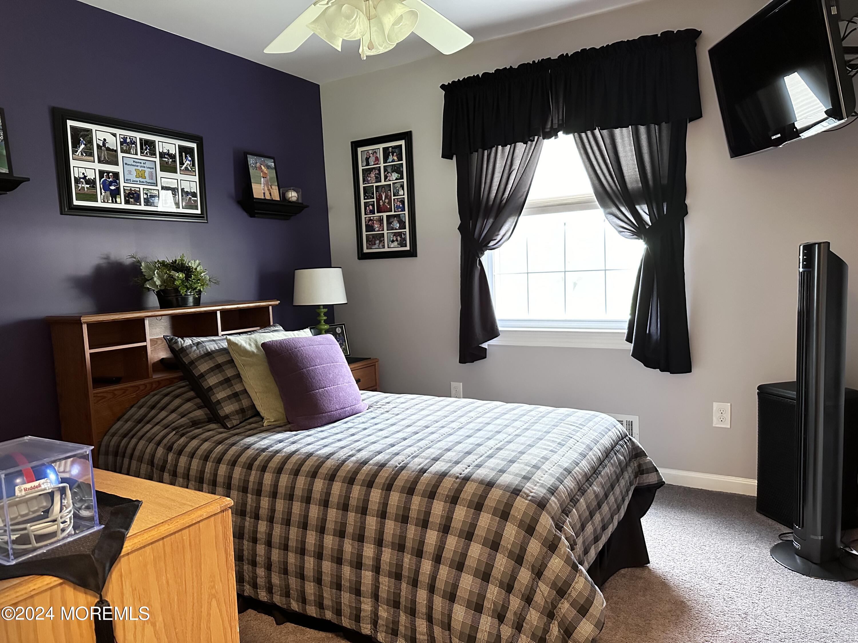 3 Springhill Drive Howell, NJ 07731 - Photo 29 of 37 a bedroom with a bed a flat screen tv and a chandelier