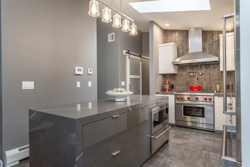 127 Howland Road Fairhaven, MA 02719 - Photo 11 of 42 a kitchen with stainless steel appliances granite countertop a stove and a refrigerator