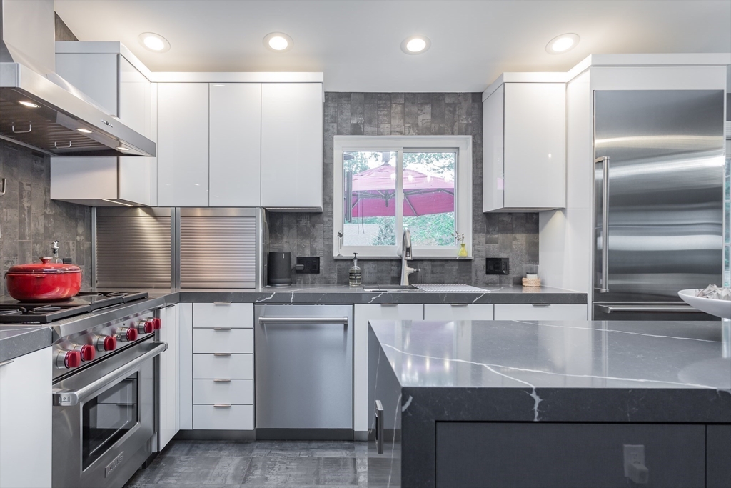 127 Howland Road Fairhaven, MA 02719 - Photo 12 of 42 a kitchen with stainless steel appliances granite countertop a sink stove and refrigerator