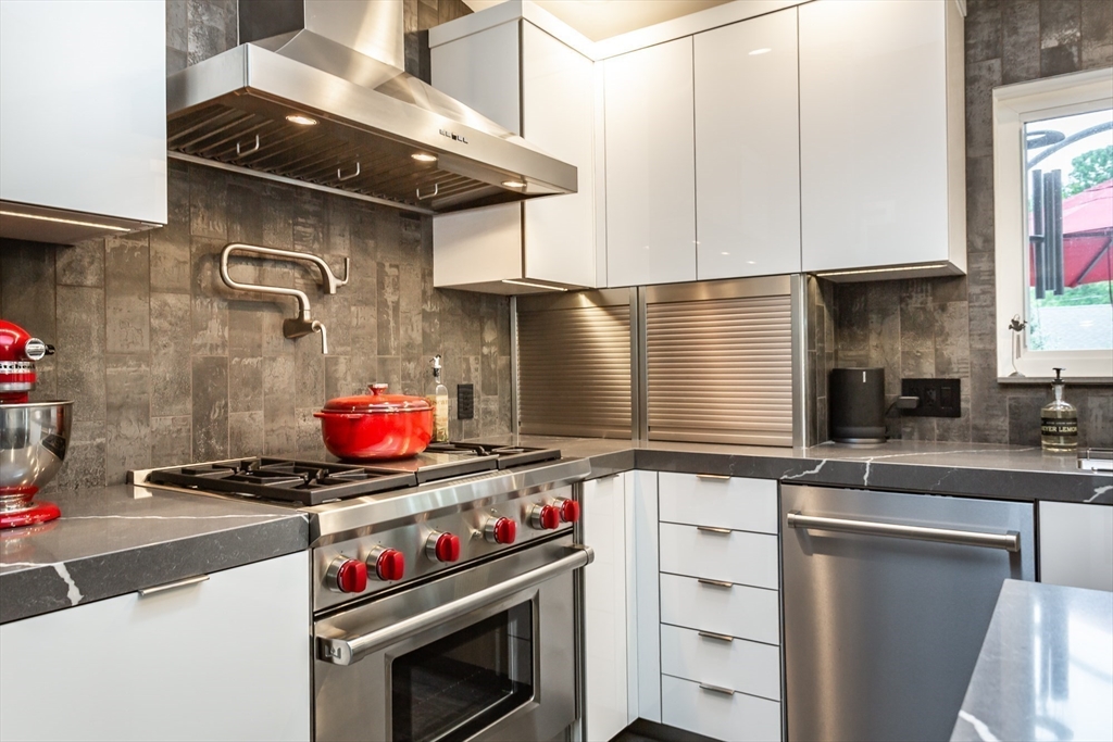 127 Howland Road Fairhaven, MA 02719 - Photo 13 of 42 a kitchen with stainless steel appliances granite countertop a stove and a sink