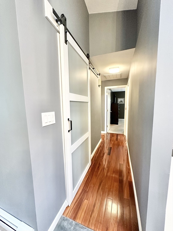 127 Howland Road Fairhaven, MA 02719 - Photo 15 of 42 a view of a hallway with wooden floor and staircase