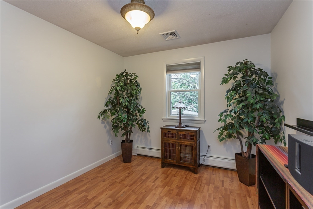 127 Howland Road Fairhaven, MA 02719 - Photo 21 of 42 an empty room with wooden floor and a window