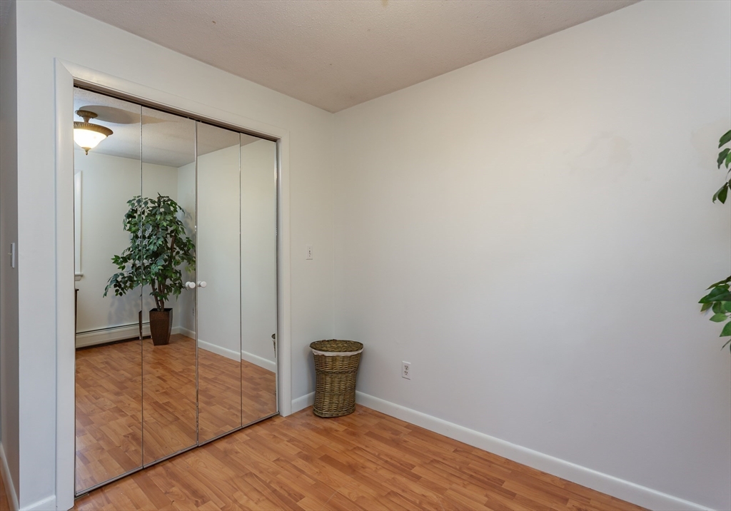 127 Howland Road Fairhaven, MA 02719 - Photo 22 of 42 a view of a small space with wooden floor and a potted plant