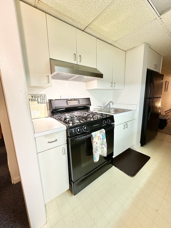127 Howland Road Fairhaven, MA 02719 - Photo 27 of 42 a kitchen with stainless steel appliances white cabinets and a stove