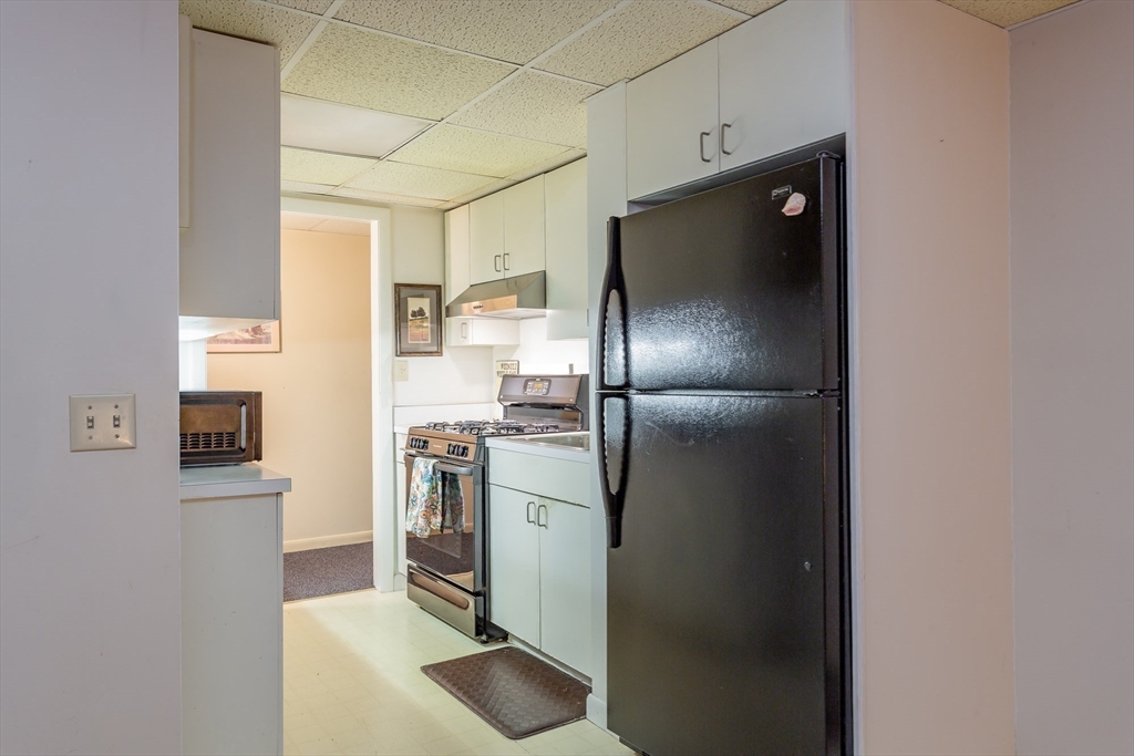 127 Howland Road Fairhaven, MA 02719 - Photo 29 of 42 a kitchen with stainless steel appliances granite countertop a refrigerator and a sink