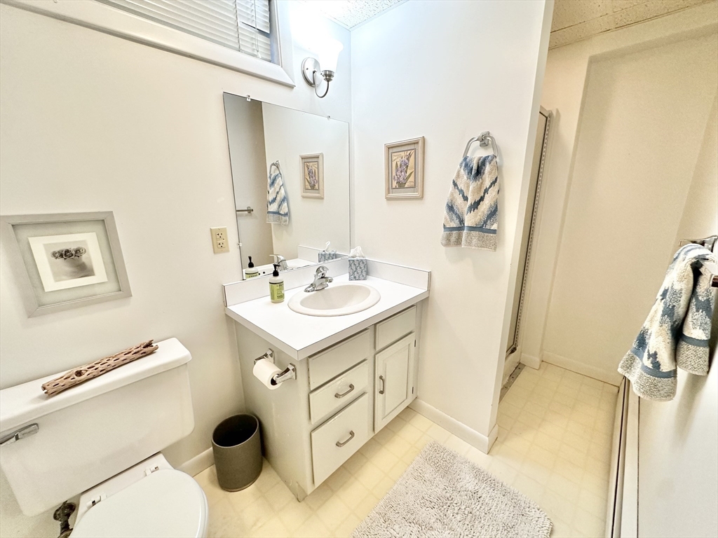 127 Howland Road Fairhaven, MA 02719 - Photo 32 of 42 a bathroom with a sink mirror vanity and toilet