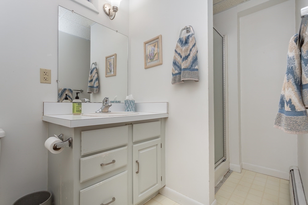127 Howland Road Fairhaven, MA 02719 - Photo 33 of 42 a bathroom with a sink mirror and vanity