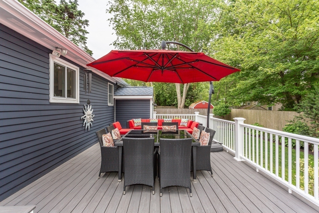127 Howland Road Fairhaven, MA 02719 - Photo 38 of 42 a table and chairs in patio of wooden house