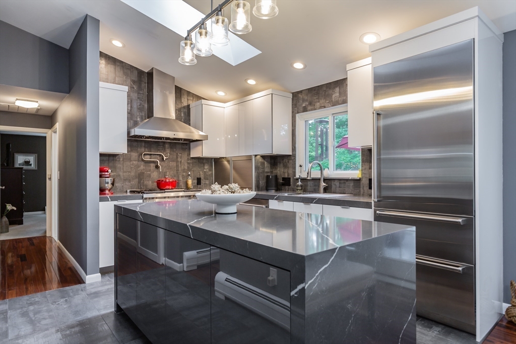 127 Howland Road Fairhaven, MA 02719 - Photo 10 of 42 a kitchen with kitchen island granite countertop stainless steel appliances lots of counter top space