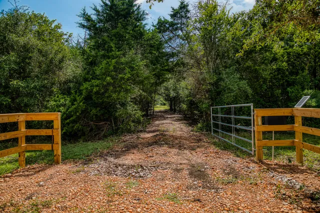 a view of an empty room with stairs and a yard