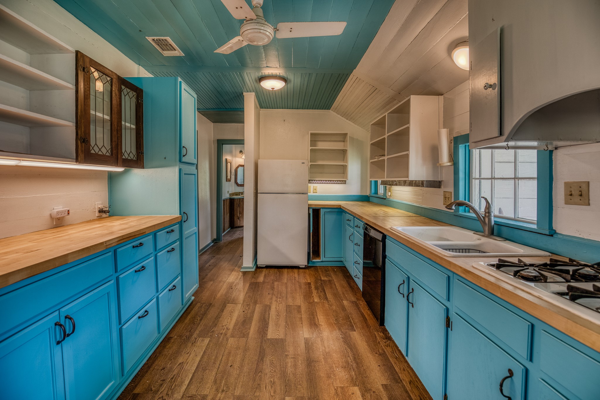 3420 Rohde Road Round Top, TX 78954 - Photo 21 of 28 a kitchen with stainless steel appliances granite countertop lots of counter top space and wooden floor