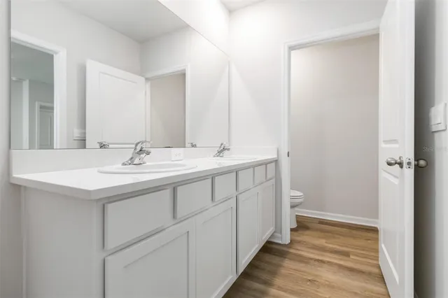 a bathroom with a double vanity sink and a mirror