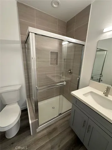 a bathroom with a granite countertop sink toilet and shower