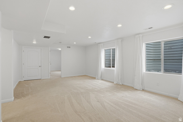 2007 Fielding Hill Lane Draper, UT 84020 - Photo 33 of 83 Spacious room featuring neutral carpeting, recessed ceiling lighting, two egress windows with white drapes, and white trim throughout