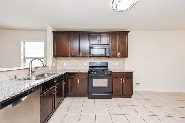 a view of a kitchen with microwave and cabinets