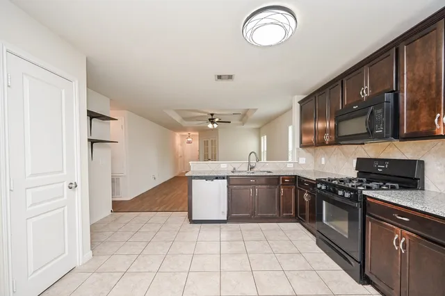 a view of a dining room with furniture a chandelier and wooden floor
