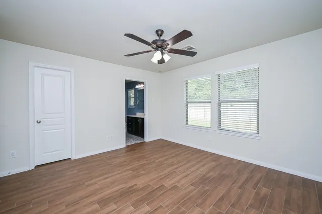 a bedroom with furniture and wooden floor