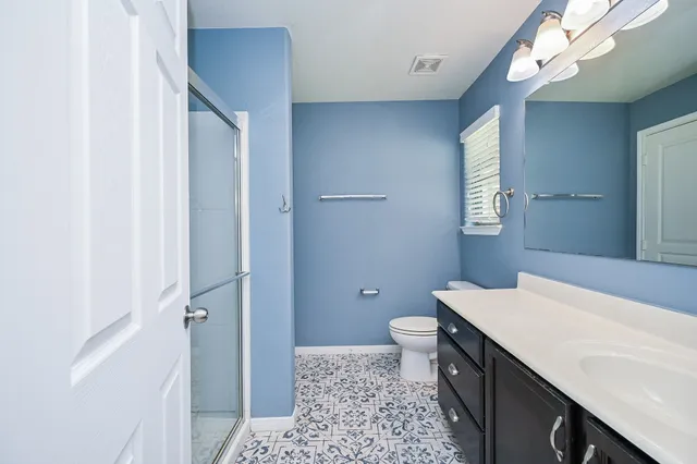 a bathroom with a toilet a sink a bathtub and mirror