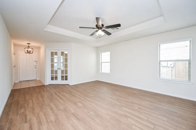 a view of a livingroom with a hardwood floor and a ceiling fan