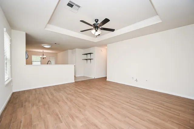 a living room with furniture a flat screen tv and a window