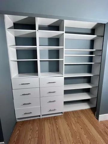 a view of walk in closet with empty racks