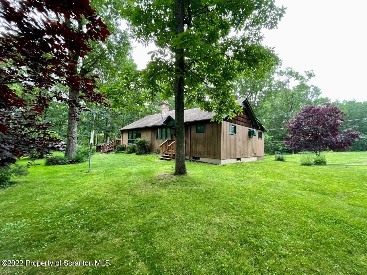 17 Center Road Hawley, PA 18428 - Photo 4 of 38 a front view of a house with a yard and tree